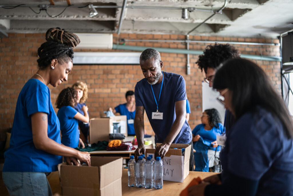 Volunteers arranging donations in a community charity donation center